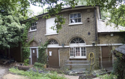Photo of the dilapidated stable block with windows visible